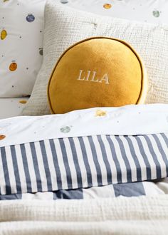 the pillows on the bed are personalized with an embroidered monogrammed pillowcase