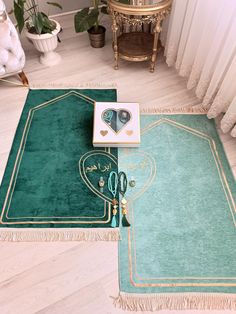 a green rug with gold trimmings on top of it next to a pair of scissors