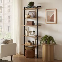 a living room filled with furniture and a tall book shelf next to a window covered in plants