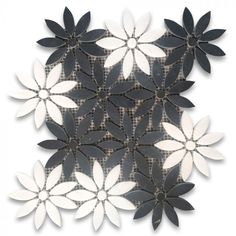 an artistically designed tile with white and black flowers