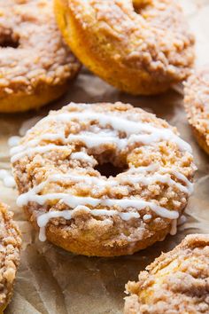 there are many doughnuts with icing on the top one is glazed and drizzled