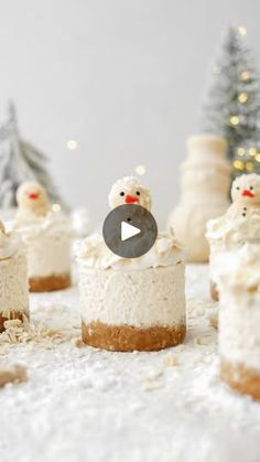 there are many small cakes with frosting and snowmen on them, all in the same row