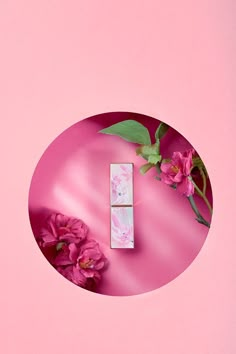 a pink background with flowers and a white box