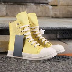 Elevate your footwear collection with the distinctive style of Rick Owens Yellow Unisex Boots. These boots encapsulate Rick Owens' vision, seamlessly combining fashion and comfort. Whether you're searching for lace-up gold sneakers with genuine leather, height-increasing features, or massage effects, these shoes are an excellent choice. Key Features: Shoes Type: Basic Fit: These boots fit true to size, offering a comfortable fit that embraces your feet's natural contours. Take your normal size for the perfect fit. Pattern Type: With a solid pattern, these boots are versatile and effortlessly complement various outfits. Insole Material: Crafted from pigskin, the insole provides exceptional cushioning and support, allowing you to walk confidently in comfort. Season: Ideal for both spring and Summer Slip-on High-top Sneakers For Streetwear, Casual High-top Summer Boots, Closed Toe Canvas Shoes For Spring Streetwear, Yellow Leather Sneakers For Summer, Summer Streetwear High-top Sneakers With Round Toe, Spring Streetwear Canvas Shoes With Closed Toe, Casual Slip-on Summer Boots, Summer Casual Slip-on Boots, Spring Canvas Boots With Round Toe