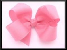 a large pink bow on top of a white background with black border around the corner