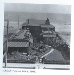 an old black and white photo of a house by the ocean