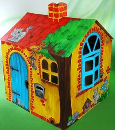 a cardboard house with animals painted on it