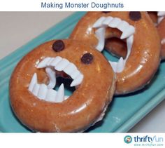 three doughnuts with fake teeth and chocolate chips on them sitting on a blue plate