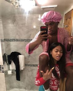 a man taking a selfie with a woman in the bathroom