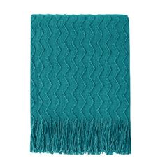 a teal blanket with fringes on it