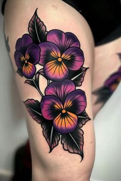 a woman's thigh with purple flowers on it