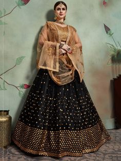 A beautiful flared black bridal designer lehenga in a net designed with heavy sequins embroidery work all over. Comes with a double-layer can-can inside and inner attached inside. 
Accompanied by a gota silk choli with similar sequins embroidered and net sequins, zari embellished dupatta, both in matching golden color.
Lehenga Length : 42 inches 
Lehenga Type: Semi Stitched 
Lehenga flair: 3.00 Meter 
Blouse:  1.00 Meter ( Unstitched ) 
Dupatta : 2.25 Meter Semi-stitched Embellished Black Anarkali Set, Festive Black Organza Set, Black Organza Sharara For Festivals, Black Embellished Organza Sets, Embellished Black Organza Sets, Black Traditional Wear For Wedding And Diwali, Traditional Black Wear For Wedding And Diwali, Black Organza Sets With Zari Work, Black Organza Dupatta For Party