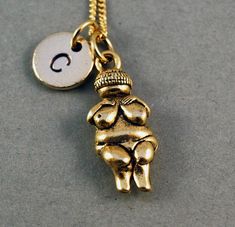 "❖ Venus of Willendorf charm in Antique Gold Pewter. Approx: 7/8 X 3/8\" Lead free pewter charm made in U.S.A. ❖ Hand Stamped Initial Charm - Antique Gold Pewter 3/8\" (9mm) ❖ Click below for Venus of Willendorf necklace in Antique Silver Pewter: https://www.etsy.com/listing/122051232 ❖ Click below for Willendorf bracelet: https://www.etsy.com/listing/156459802 ❖ Add a birthstone or Freshwater pearl for $3.50 https://www.etsy.com/listing/110444872 ❖ Additional Hand Stamped Initial Charms $4.50 e Symbolic Personalized Brass Charm Necklaces, Personalized Symbolic Brass Charm Necklaces, Personalized Brass Charm Necklaces, Venus Of Willendorf, Necklace Woman, Gold Initial Necklace, Antique Pewter, Gold Initial, Cat Necklace