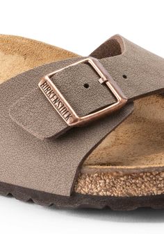 The BIRKENSTOCK Madrid is the oldest member of the family of models, making it a veritable classic. Launched as a “gymnastics sandal" half a century ago, this simple single-strap model has gone on to become a firm fashion favorite. The upper is made from the skin-friendly, hard-wearing synthetic material Birko-Flor® in a sophisticated nubuck look which boasts a texture and color that could almost be mistaken for real leather. Anatomically shaped cork-latex footbed Upper: Birko-Flor® nubuck Footb Classic Adjustable Slides With Leather Footbed, Classic Adjustable Slip-on Footbed Sandals, Classic Footbed Sandals With Double Strap And Adjustable Fit, Classic Adjustable Sandals With Textured Footbed, Classic Sandals With Buckle Closure For Everyday, Thrift Haul, Birkenstock Madrid, Just Peachy, Ring Pendant Necklace