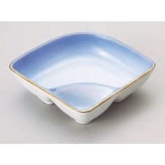 a blue and white square bowl with gold trimmings on the edge, sitting on a table