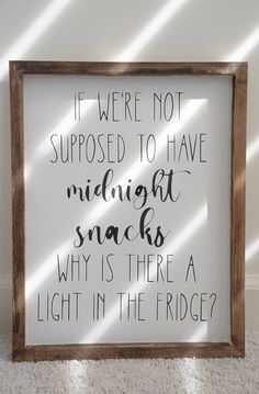 a sign that says if we're not supposed to have midnight snacks, why is there a light in the fridge?