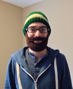 a man with a beard wearing a green and yellow knitted hat