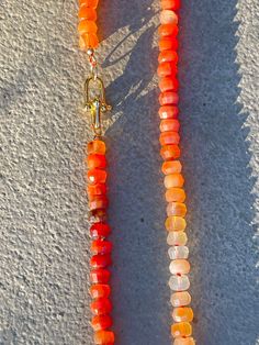 Orange Ombre Natural Carnelian Necklace, Hand Knotted on Silk Thread, Statement Piece for Fall, Stunning Jewelry Gift for Her Sparkling orange 6x10mm faceted carnelian beaded necklace with unique gold plated clasp. A bold and unique statement piece.  Beads: Natural Carnelian faceted rondelle beads 10x6 mm in size.  Silk Color: Coral shown, can be customized to your liking Length: Customizable I am dedicated to shipping your order as soon as possible. Ready to ship pieces will be sent out within Orange Carnelian Polished Beads Necklace, Luxury Carnelian Orange Necklace, Polished Carnelian Orange Jewelry, Artisan Hand-strung Carnelian Necklace, Hand-strung Orange Carnelian Necklaces, Orange Ombre, Carnelian Necklace, Color Coral, Carnelian Beads