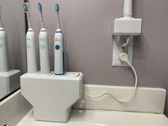 Custom 3D printed wall mount or countertop holder/organizer for electric toothbrush chargers. Hide the cords and de-clutter your bathroom counters. Options to hold 4X or 3X electric toothbrush chargers and includes an internal power strip to plug all in and only have 1 cord going out to the outlet. The cord has a maximum length of 4ft, any excess can be coiling up inside the unit. The power strip also includes USB charging parts for charging phones, etc. Chargers are not included Color: White as Electric Toothbrush Storage, Electronic Toothbrush, Counter Clutter, Sonicare Toothbrush, Toothbrush Organization, Wall Mounted Toothbrush Holder, Electric Toothbrush Holder, Grey Headboard, Toothbrush Holders