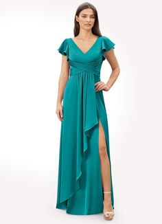 a woman in a long green dress with a slit down the side and one leg