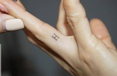 a person with a small tattoo on their left hand