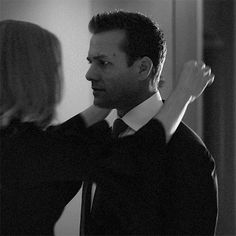 black and white photograph of man adjusting woman's tie