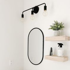 a bathroom with a sink, mirror and shelves on the wall next to each other