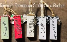 four wooden tags hanging from twine with words on them that read, tammy's farmhouse craft as a budget