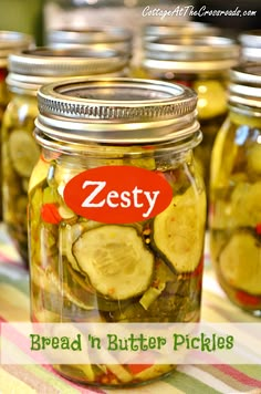 several jars filled with pickles on top of a table