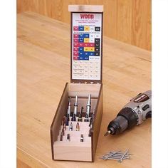 a wooden box filled with different types of screwdrivers and tools on top of a table