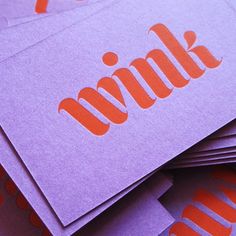 several purple and orange business cards with the word think on them