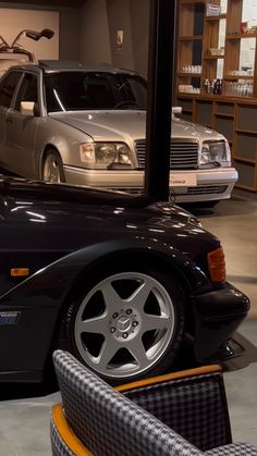 two cars parked next to each other in a garage