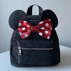 New Disney Minnie Mouse Mini, Faux Suede Backpack, With Metallic Red Bow. The Softest Faux Suede On The Exterior With The Classic Minnie Mouse Bow. Silver Accents On The Hardware. Adjustable Straps On The Back. Smoke Free And Pet Free Home. Disney Bonding, Classic Minnie Mouse, Suede Backpack, Minnie Mouse Bow, Disney Bag, Red Bow, Silver Accents, Faux Suede, Black Red