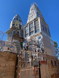 a tall building with lots of windows and decorations on it's front gate, surrounded by other buildings