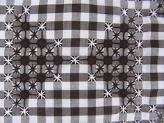 a black and white checkered table cloth with small stars on the center in squares