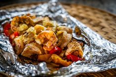 some food that is on top of tin foil in a basket and sitting on a table