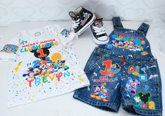 two pairs of children's clothing, one with mickey mouse and the other with mickey mouse