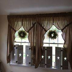 the window is decorated with wreaths and stars