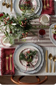 the table is set with silverware and red napkins