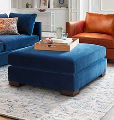 a living room with two couches and a coffee table on top of a rug