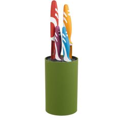 three colorful toothbrushes in a green cup