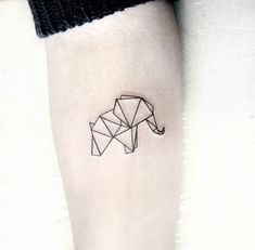 a black and white photo of an origami elephant tattoo on the left inner forearm