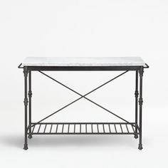 an iron and marble top console table with two shelfs on each side, against a white background