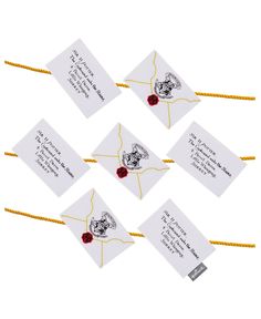 six harry potter envelopes with red roses tied to the front and back of them