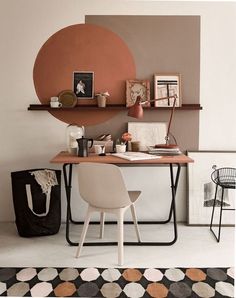 a room with a desk, chair and shelves on the wall next to each other