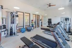 an exercise room with treadmills and other equipment