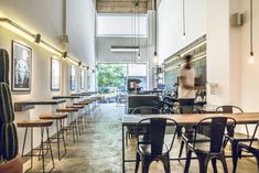 the interior of a restaurant with tables, chairs and cactus plants on the counter top