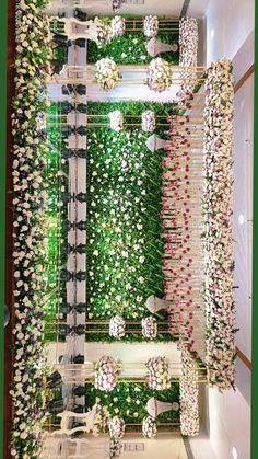 an arrangement of flowers and greenery on display in a store