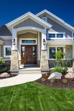 a nice house with landscaping and grass in the front yard