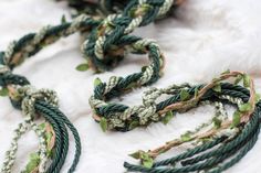 several braided green and white items laying on top of a fur covered floor next to each other